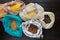 Pasta, rice, buckwheat and groats in reusable cotton bags on the black wooden table in the kitchen. Zero Waste concept. Top view.