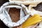 Pasta, rice, buckwheat and groats in reusable cotton bags on the black wooden table in the kitchen. Zero Waste concept. Top view.