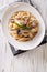 Pasta with roasted porcini mushrooms and parmesan close-up. vert