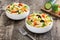 Pasta salad in a bowl on rustic wooden table