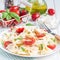Pasta salad with tie pasta, feta cheese, cherry tomatoes, mustard and basil, square