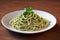 Pasta with sauce in plate. Appetizing spaghetti with pesto. Generative AI.