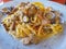 Pasta with sea fruit in white plate with soft light, angle view. Spaghetti ai frutti di mare, seafood mediterranean gastronomy
