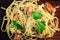 Pasta with seafood, prawns and mussels, sprinkled with leaves of
