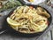 Pasta with seafood, shellfish clams in the iron pan portion, with lemon and seasoning