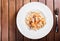 Pasta with seafood, shrimp, mussels, octopus, oysters, herbs and cream sauce on wooden background