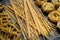 Pasta shapes, spaghetti, fusilli, and tagliatelle, Italian cuisine ingredients on a wooden background