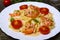 Pasta with shrimp, tomatoes, herbs and cream sauce.