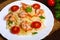 Pasta with shrimp, tomatoes, herbs and cream sauce.