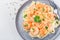 Pasta with shrimps in creamy parmesan cheese and garlic sauce garnished with parsley, fettucini alfredo, horizontal, top view,