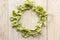 Pasta with spinach in the form of bows on wooden table in the shape of circle, wreath