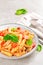 Pasta spirali stirred with fried pieces of chicken, cherry tomatoes