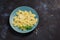 Pasta sprinkled with cheese served on a blue plate.