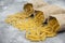 Pasta Tagliatelle and spiral italian pasta on brown wooden table