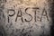 Pasta text on flour top view