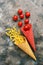 Pasta and tomatoes in multi-colored waffle cones on a rustic background. Top view, overhead, flat lay.