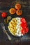 Pasta with tomatoes and white cheese. Vegetarian bowl with pasta, tomatoes and feta.