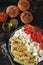 Pasta with tomatoes and white cheese. Vegetarian bowl with pasta, tomatoes and feta.