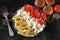 Pasta with tomatoes and white cheese. Vegetarian bowl with pasta, tomatoes and feta.