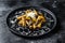 Pasta tortiglioni with black truffle, white mushroom, Cream Sauce and parmesan cheese. Black background. Top view