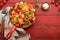 Pasta Tortiglioni with tomato sauce, baked cherry tomatoes, mozzarella and parmesan cheese, basil on old red rustic table.