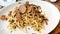 Pasta with truffles in a mushroom sauce, close up on a white plate
