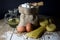 Pasta, Two Eggs, Jute Bag Filled with Flour, Wooden Spoon and Olive Oil in Glass Bottle on Wooden Table, Black Background