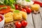 Pasta, vegetables, herbs and spices for Italian food on rustic wooden table