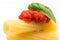 Pasta in white background. Rigatoni, tomato and basil on fork. Italian cuisine concept