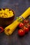 Pasta in a wooden bowl, spaghetti, tomatoes and basil