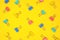 Pasted paper clip pattern, top view on a bright yellow background