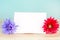Pastel artificial flower with white note paper