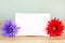 Pastel artificial flower with white note paper