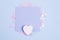 Pastel blue blank card mockup and white wooden heart on pastel blue background with scattered glitter stars. Flat lay background