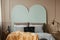 Pastel blue headboard of king size bed with cozy bedding and pillows