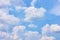 Pastel blue sky with white heap clouds
