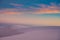 Pastel Clouds Dance Over White Sand Dunes