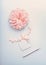 Pastel color mock up with cream pink flower , blank paper card with ribbon and point pen on light blue desktop background