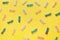 Pastel colored baby confetti on yellow background