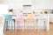 pastel-colored counter chairs lined up in a bright, modern kitchen