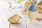 Pastel colored Easter decor eggs in a white wooden table