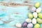 Pastel colored easter eggs on wooden background