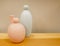 Pastel colored vases on a wooden shelf