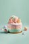 Pastel colors mini birthday cake over green background.