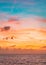 Pastel colors ocean sunset, warm and cyan clouds sky