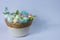 Pastel colour easter eggs with flowers in basket