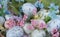 Pastel colour easter eggs with flowers in basket close up