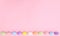 Pastel Easter eggs on bright pink background neatly ordered. Spring holidays copy space concept