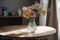 pastel flowers in vase on sleek wooden table