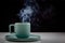 Pastel green colored coffee or tea cup with hot liquid, smoke and steam, black background